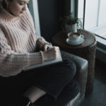 woman writing in notebook