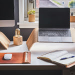 desk with laptop and notebook