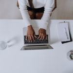 woman typing on laptop