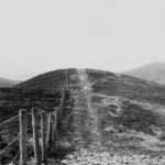 mountain trail with fence