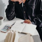 person sitting at a table writing