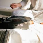 person sitting in front of a record player