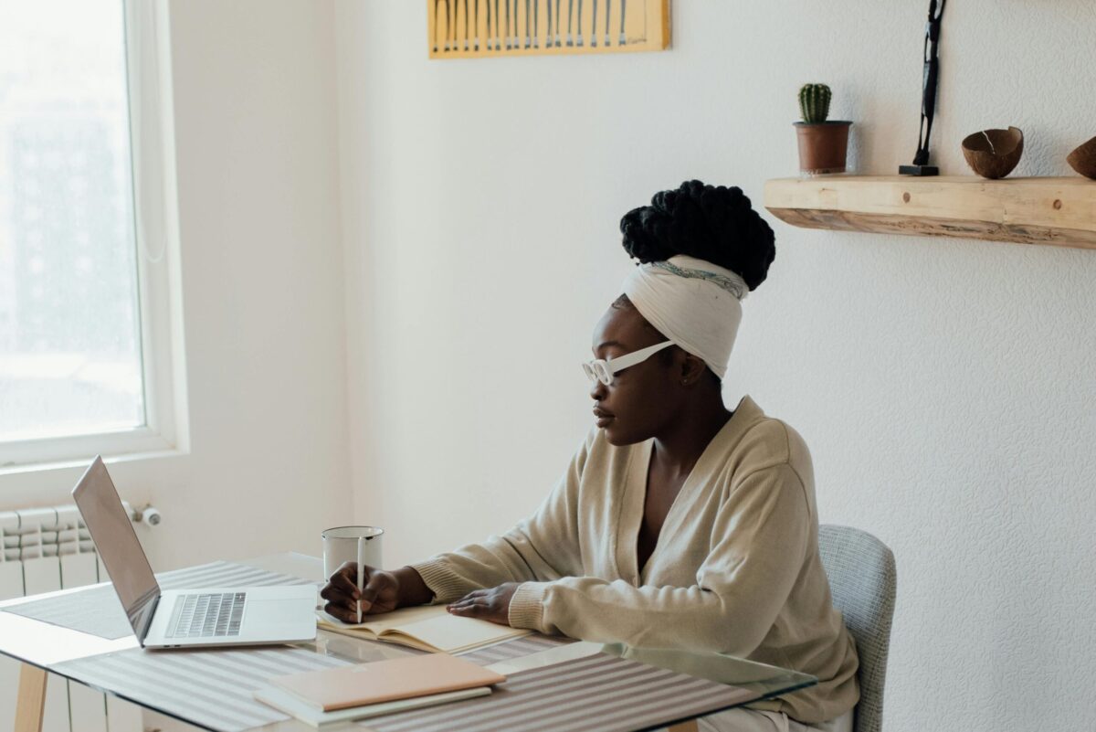 person writing at a table