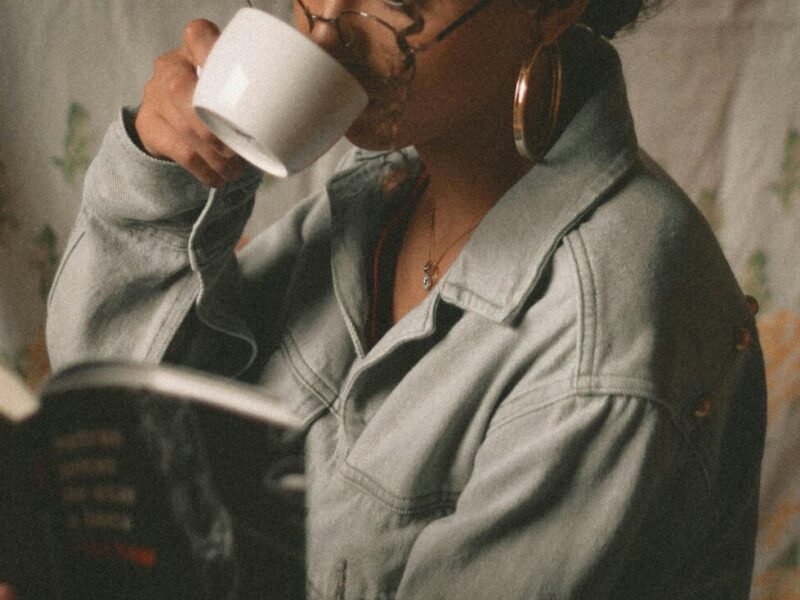 person drinking tea and reading a book