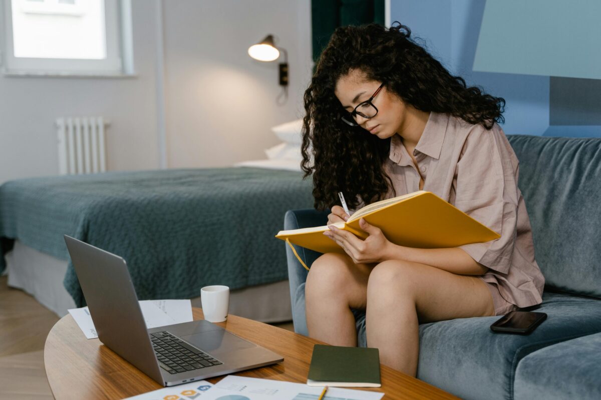 person in front of a computer writing