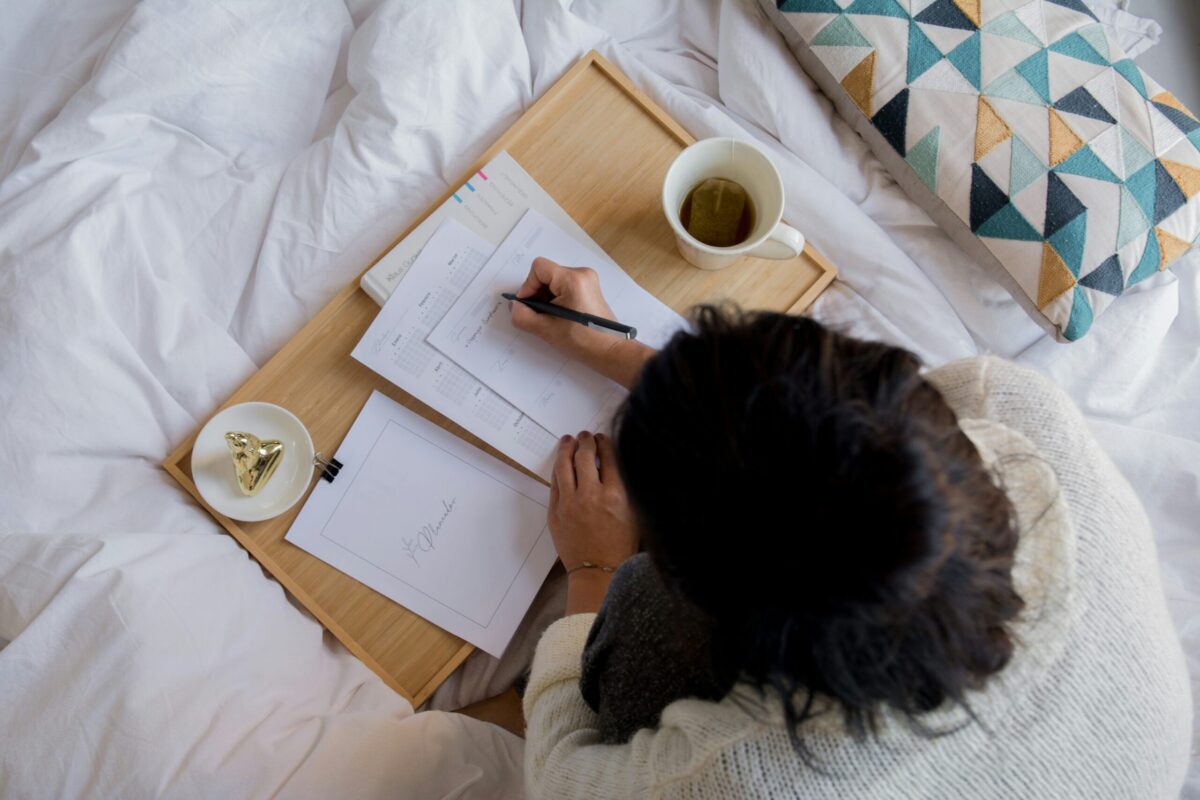 person writing in bed